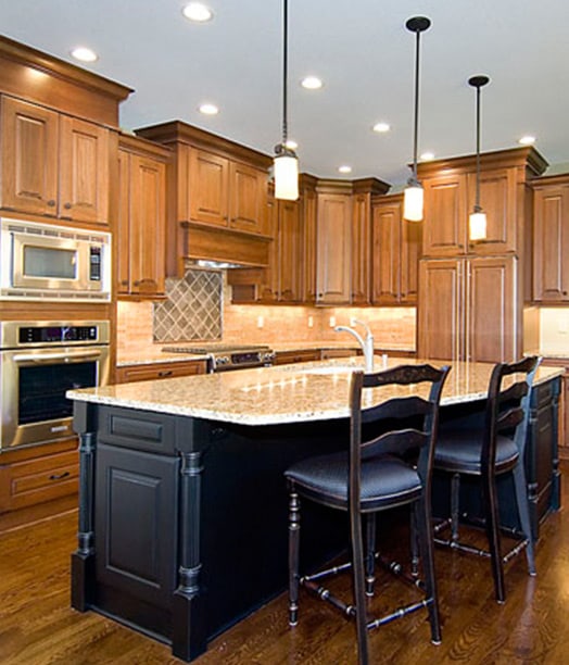 kitchen remodel with warm cabinetry and stone counter tops