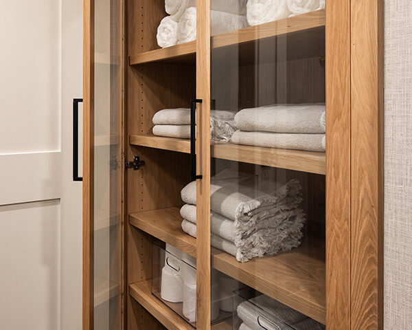 Built in glass front cabinet in guest bathroom