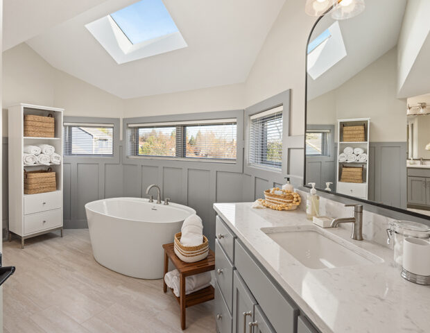 Beautiful blue wainscotting surrounds stand-alone tub in Boyer Building remodel.