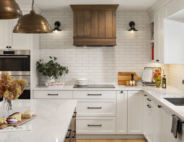 Boyer Building beautiful white kitchen with custom wood hood.