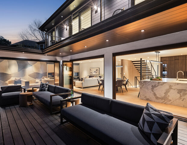 Deck view into main floor kitchen and great room with bi-fold windows/doors in St Albans Bay Lake Minnetonka Boyer Building Remodel