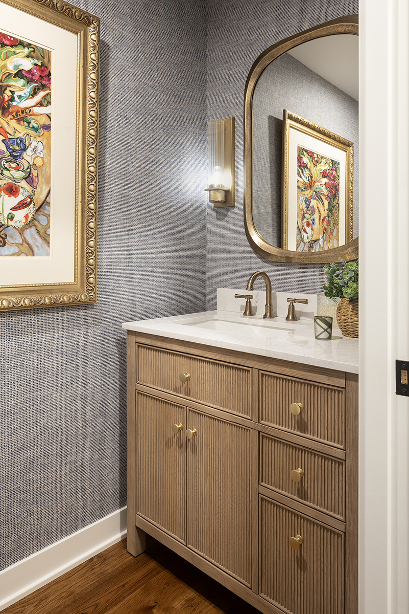 Powder bathroom with blue navy wallpaper