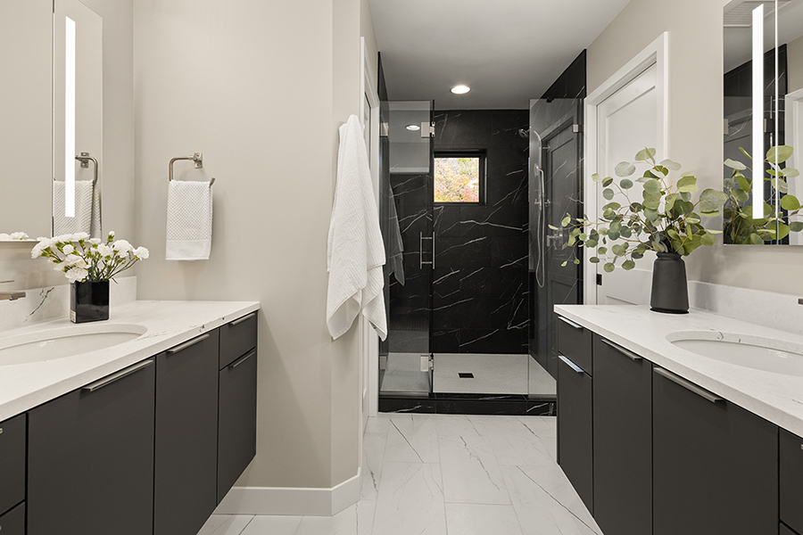 Black, masculine primary bathroom in a Boyer Building new build has every tile and design to make this a sleek bathroom and retreat. 