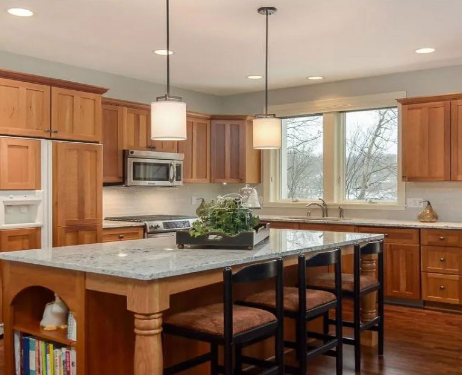 Before image, granite counter top with dark wood cabinetry.