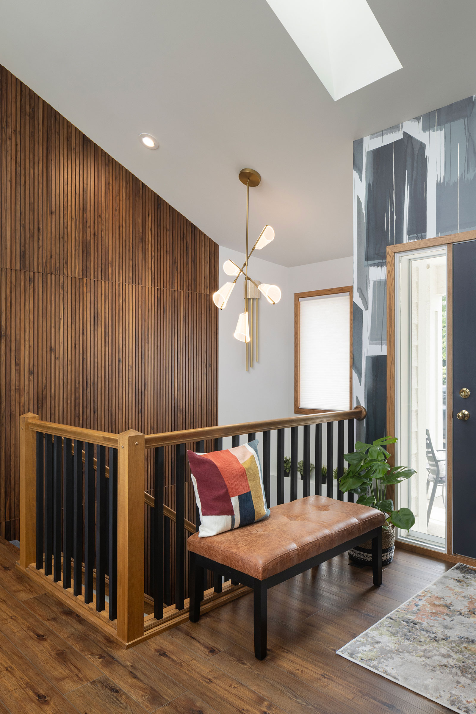 Fluted wall treatment adds interest in main stairwell near front door