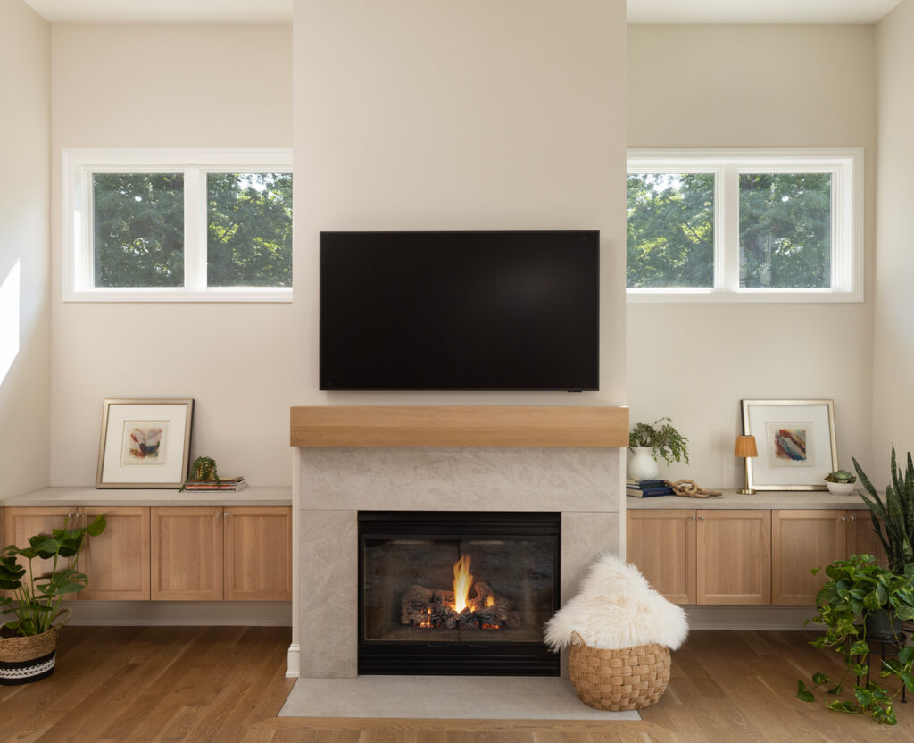 Beautiful new white oak mantel and floating cabinetry with stone surround.