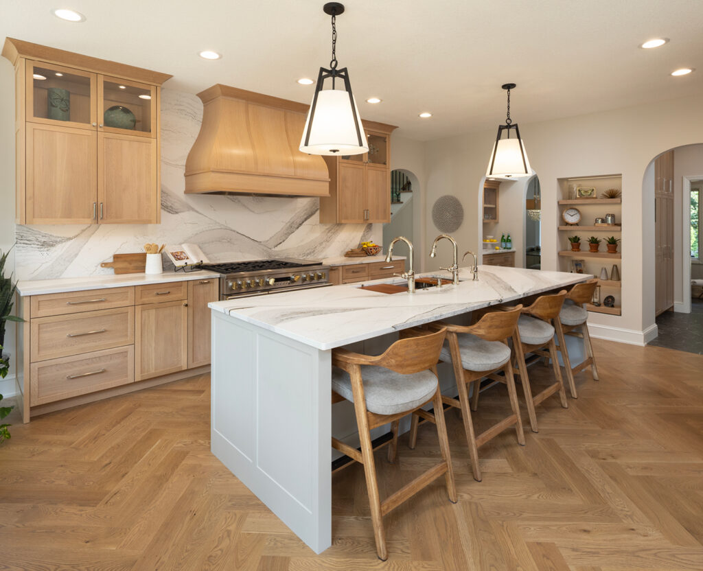 Beautiful Minnetonka after photos of our kitchen with herringbone wood floor and waterfall island