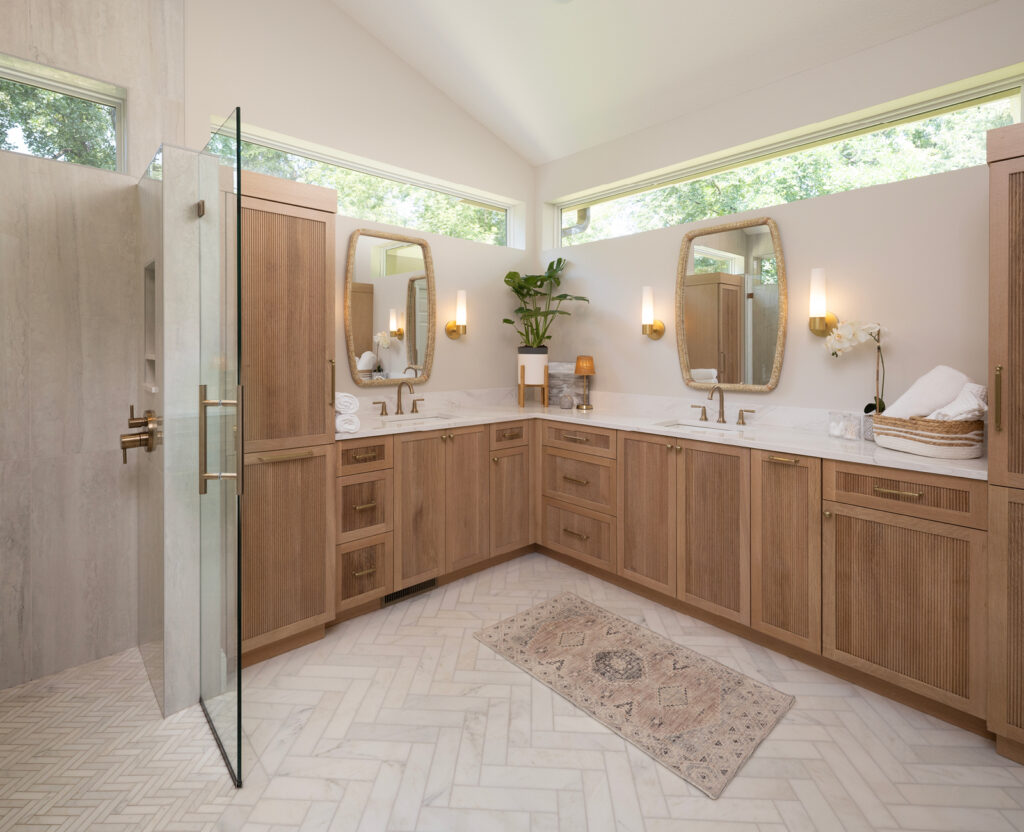 Stunning, white oak cabinetry and curbless shower with beautiful transom windows.