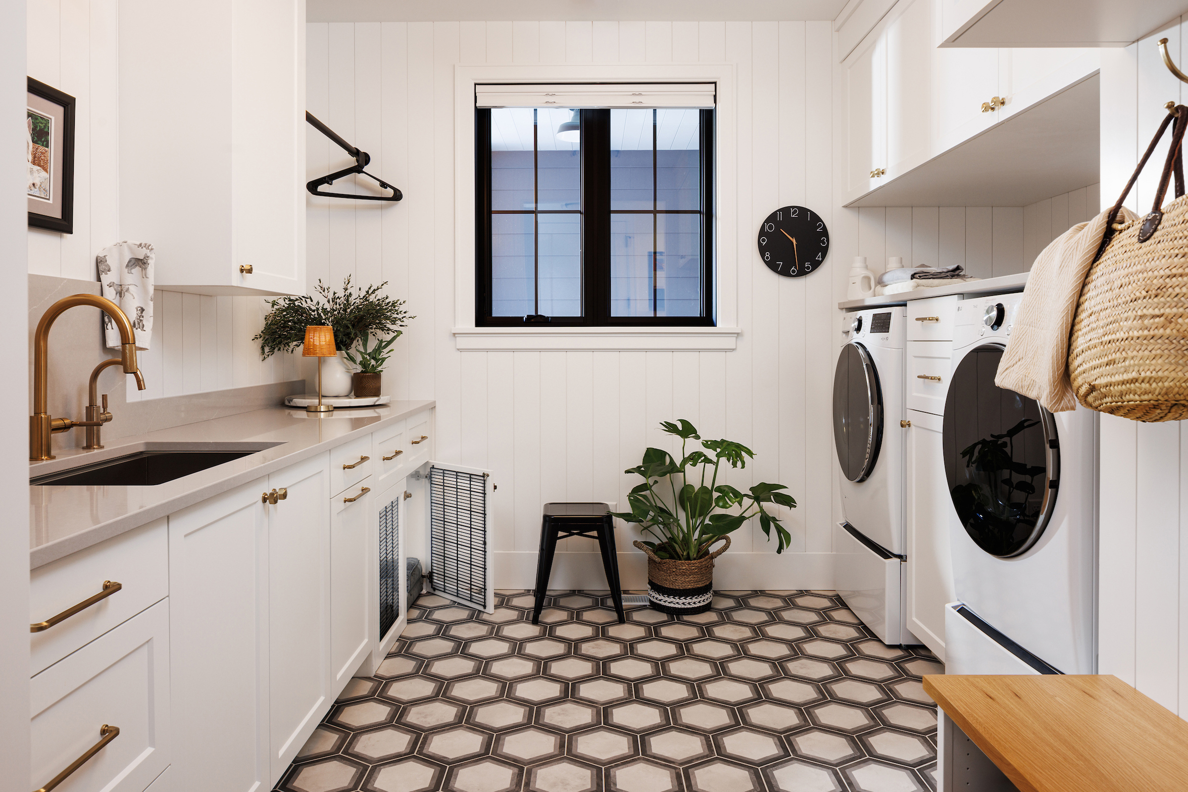 Boyer Building Custom Build laundry and mud room with built in pet cabinetry. Beautiful shiplap and ceramic hexagon tile.