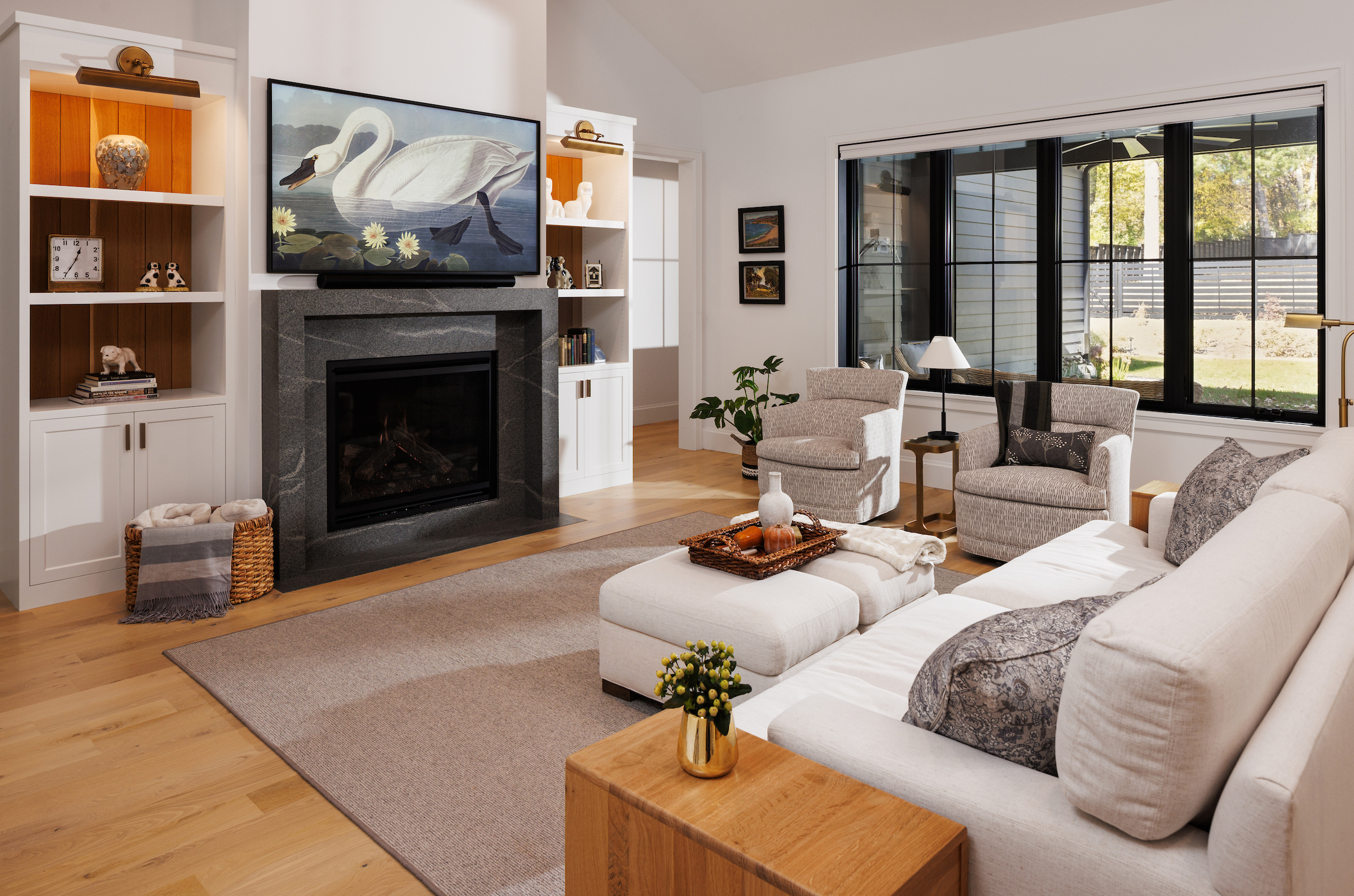 Boyer Building custom home with spacious open layout of living room and large Marvin windows off of screen porch.